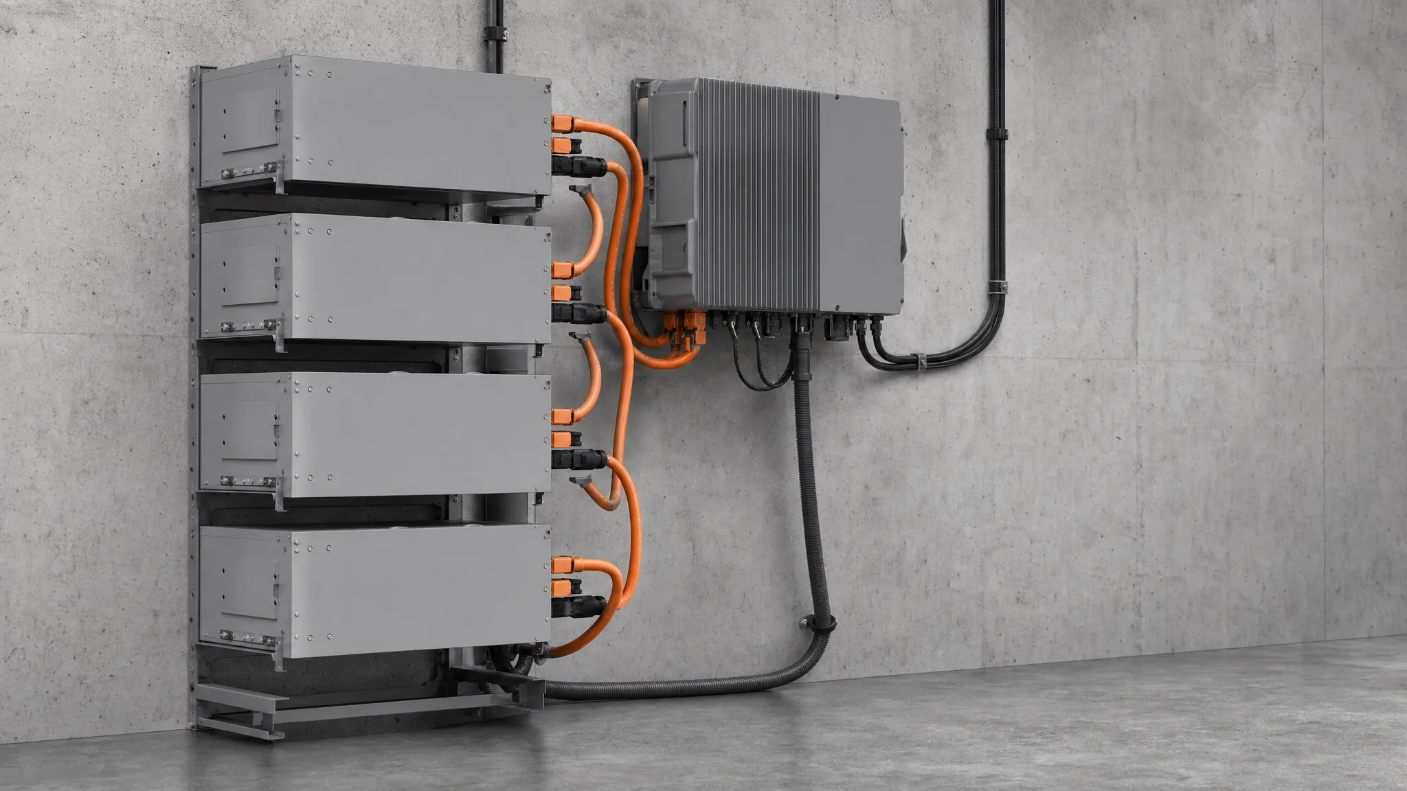 A high-voltage battery stack wired to a wall-mounted hybrid inverter in a home energy installation